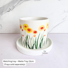 Load image into Gallery viewer, planter with floral design on a matching tray, The Leaferie brand visible
