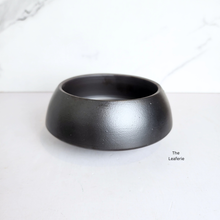 Load image into Gallery viewer, Black ceramic planter on a white background with &#39;The Leaferie&#39; branding.
