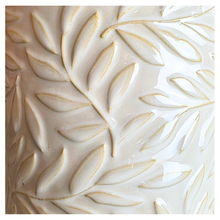 Load image into Gallery viewer, Silas White ceramic planter with leaf pattern on a gray surface, branded 'LEAFERIE'.
