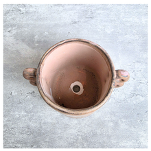 Load image into Gallery viewer, Dovra Brown ceramic planter with handles on a light gray surface, branded 'LEAFERIE'.
