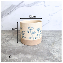Load image into Gallery viewer, Evie floralCylindrical fabric basket with blue floral patterns on a light background, featuring the brand 'LEAFERIE'.
