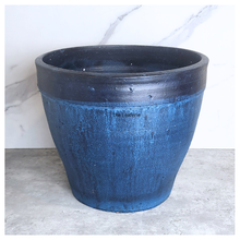 Load image into Gallery viewer, Blue and black planter on a marble surface
