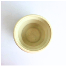 Load image into Gallery viewer, A ceramic planter pot with a wavy, ribbed design in a speckled cream-beige glaze, set against a white marble-patterned background. The brand name 'LEAPERIE' is visible at the top, and the product name 'Petelle' is shown at the bottom left.
