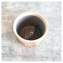 Load image into Gallery viewer, Sorel Floral-patterned candle with 'LEAFERIE' branding on a marble 
