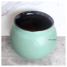 Load image into Gallery viewer, The Leaferie Aalto round green and white ceramic flowerpot. 
