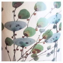 Load image into Gallery viewer, Close-up of a floral pattern featuring green and blue leaves on a beige background.
