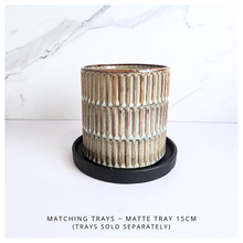 Load image into Gallery viewer, Elira Ceramic pot with ribbed texture on a white background, featuring the Leaferie brand.
