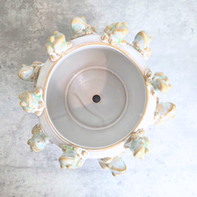 Load image into Gallery viewer, An overhead view of a round ceramic planter or decorative pot with a wide rim adorned with small sculpted frog figures in pale green, gold, and cream tones, set against a light gray textured background.
