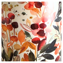 Load image into Gallery viewer, Sorel Floral-patterned candle with 'LEAFERIE' branding on a marble 

