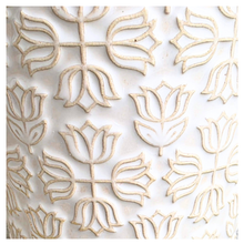 Load image into Gallery viewer, An off-white ceramic planter with a textured, embossed floral pattern, displayed on a gray stone surface against a white marble background. The brand name 'LEAFERIE' is visible at the top, and the product name 'Colette' is shown at the bottom left.
