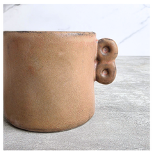 Load image into Gallery viewer, Dovra Brown ceramic planter with handles on a light gray surface, branded 'LEAFERIE'.
