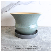 Load image into Gallery viewer, Soren Green ceramic vase with gold rim on a light gray surface, branded 'LEAFERIE'.
