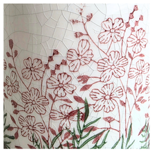 Load image into Gallery viewer, Lumelle Ceramic planter with floral design on a gray surface, featuring the brand 'LEAVERIE'.
