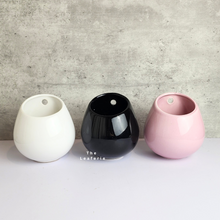 Load image into Gallery viewer, The Leaferie Aya Wall Hanging Pot. 3 colours. white, pink and black ceramic pots. 
