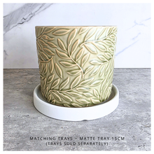 Load image into Gallery viewer, Nyra Green ceramic planter with leaf pattern on a gray surface, featuring the Leaferie brand.
