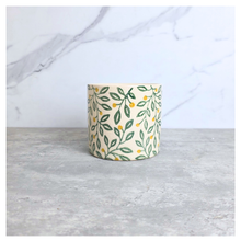 Load image into Gallery viewer, Aurelia Decorative pot with leaf pattern on a marble surface, featuring the brand 'LEAFAERIE'.
