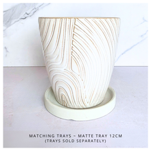 Load image into Gallery viewer, Nivelle Ceramic planter with marbled design on a marble background, featuring the brand 'LEAFAERIE'.
