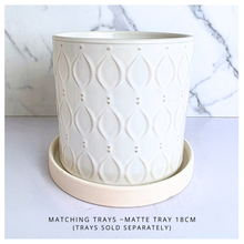 Load image into Gallery viewer, An off-white ceramic planter with a textured geometric leaf pattern, shown against a white marble background. The brand name 'LEAFERIE' is visible at the top, and the product name 'Oriva' is displayed at the bottom left.
