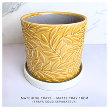 Load image into Gallery viewer, Marigold Yellow ceramic pot with leaf pattern on a marble background, featuring the Leaferie brand.
