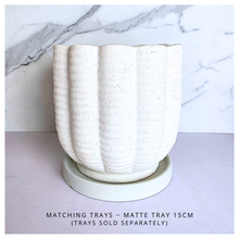 Load image into Gallery viewer, Ripple White ceramic planter with wavy texture on a marble background, featuring the Leaferie brand.
