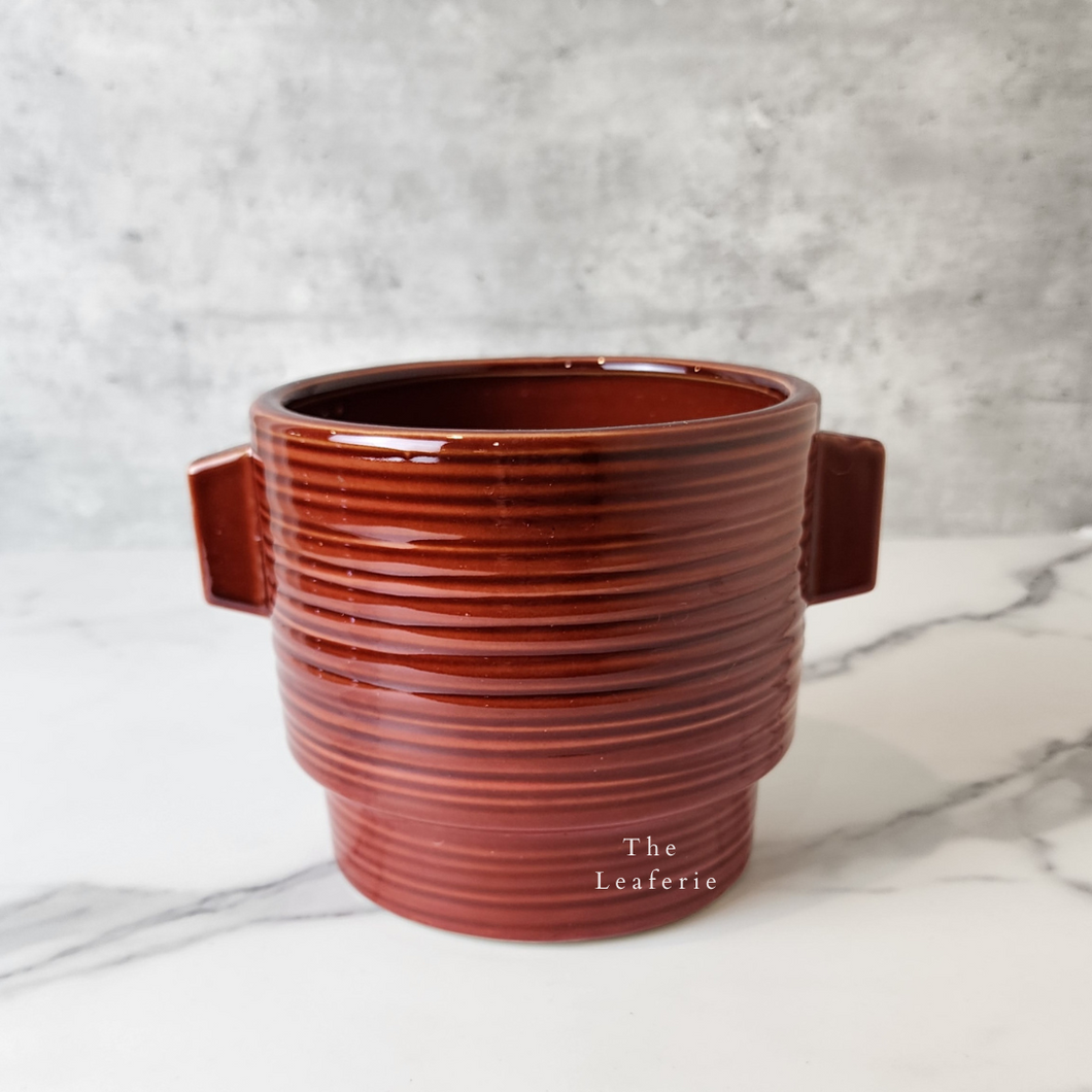 The Leaferie Aizen plant pot. red ceramic flowerpot. front view