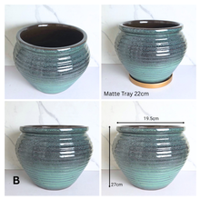 Load image into Gallery viewer, Avira by Leaperie, featuring a textured, ribbed glaze that transitions from a dark brown at the top to a vibrant teal-green at the base. The pot is shown from the front, side, and bottom angles against a white marble background.
