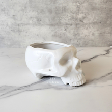 Load image into Gallery viewer, The Leaferie Comee skull plant pot. Side view . white colour
