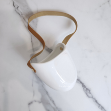 Load image into Gallery viewer, The Leaferie PAtina hanging planter. material ceramic.white colour with leather strap. no drainage hole. front view

