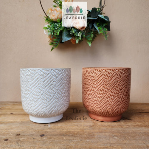 The Leaferie Bronagh Plant pot. ceramic white and orange pot . front view