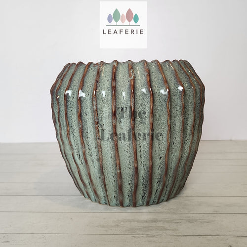 The Leaferie Brise plant pot . green ceramic pot . front view