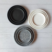 Load image into Gallery viewer, The Leaferie Ceramic round trays . top view. Black , white and speckled grey colour. 

