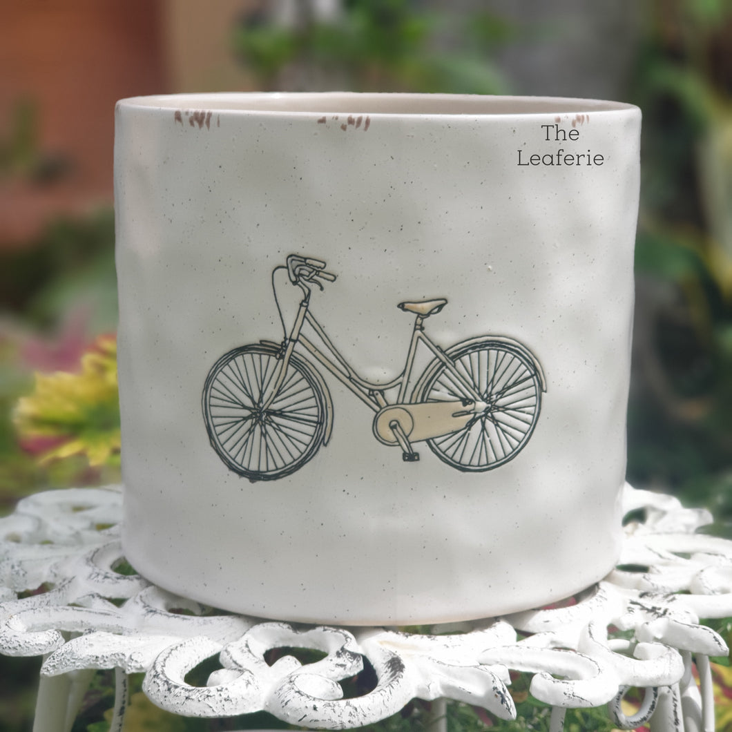 The Leaferie colson bicycle plant pot. ceramic bike planter . front view