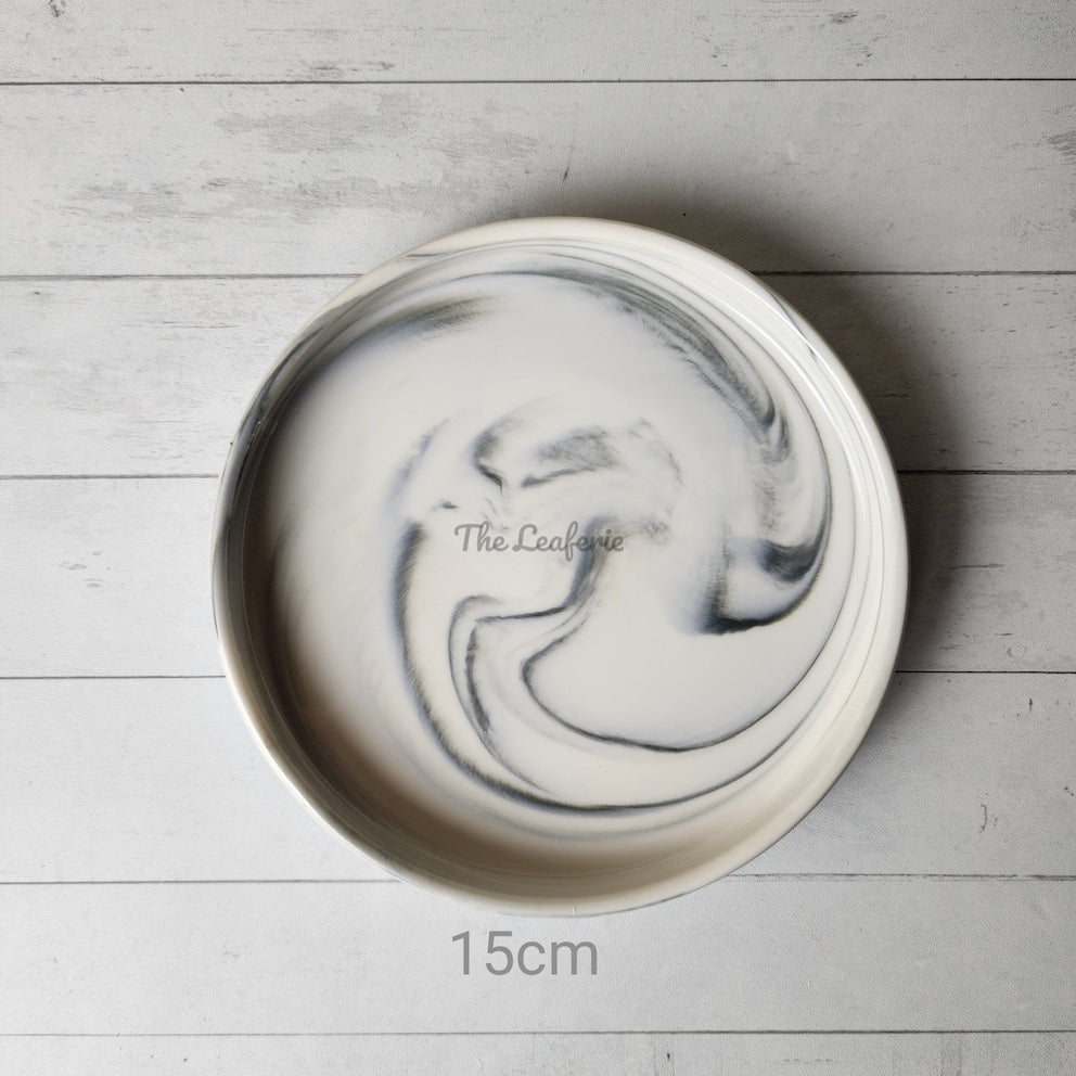 The Leaferie Marbled like round ceramic trays. 6 designs. white marble . top view of size 15cm