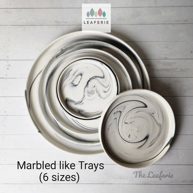 The Leaferie Marbled like round ceramic trays. 6 designs. white marble . top view of all 4 sizes.