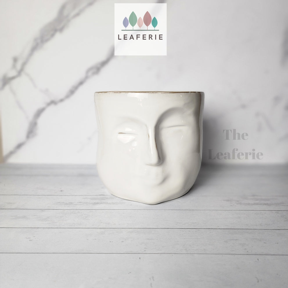 The Leaferie Faustine face white ceramic pot. front view