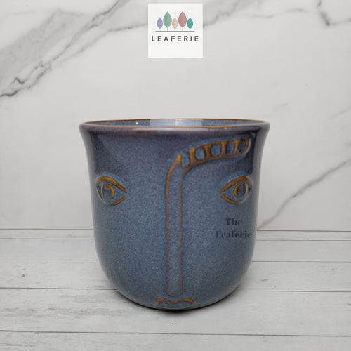 The Leaferie Lya face blue ceramic pot